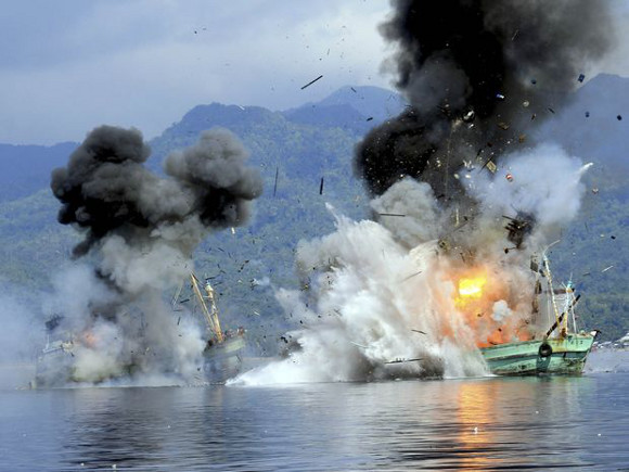 Two foreign flagged fishing boats registered in Papua New Guinea are destroyed by the Indonesian navy. Photo: Antara Foto