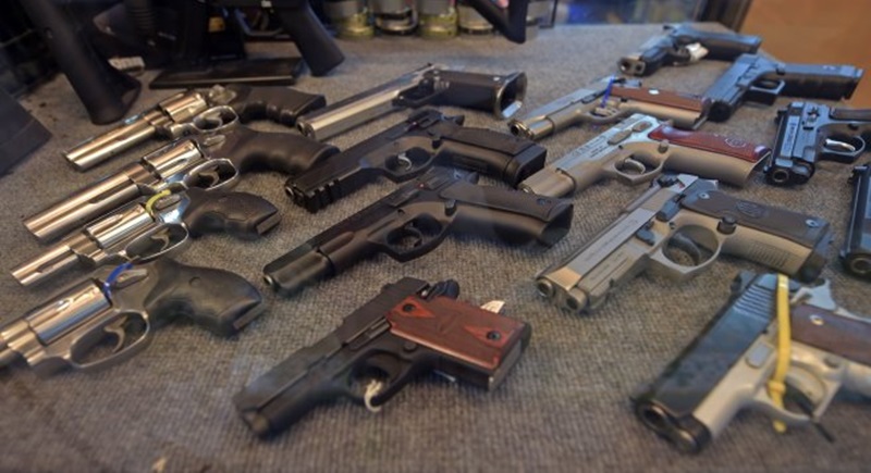 This photo taken on July 22, 2015 shows handguns displayed at a gun shop in Bangkok. Some 6.1 million firearms are registered in Thailand with its 67 million-strong population. Photo: AFP