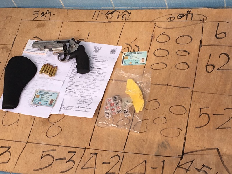 One legally registered handgun was found at the scene, as was gambling paraphernalia for the popular ;High-Low' game. Photo: Royal Thai Navy