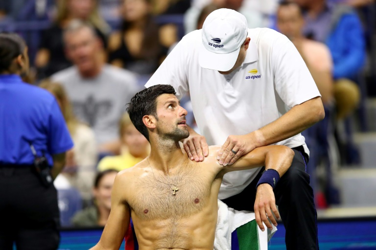 Hurting Djokovic, slow-starting Federer win at rain-hit US Open