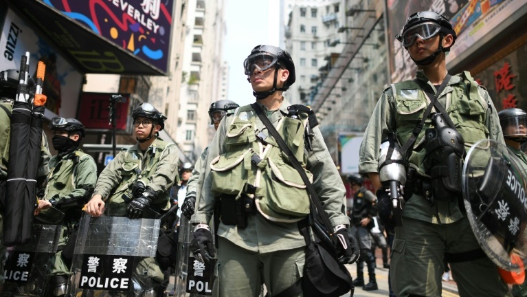 Hong Kong police fire tear gas at protesters in shopping district