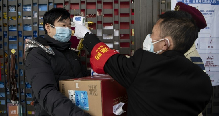 Virus death toll surges as China changes way it counts cases