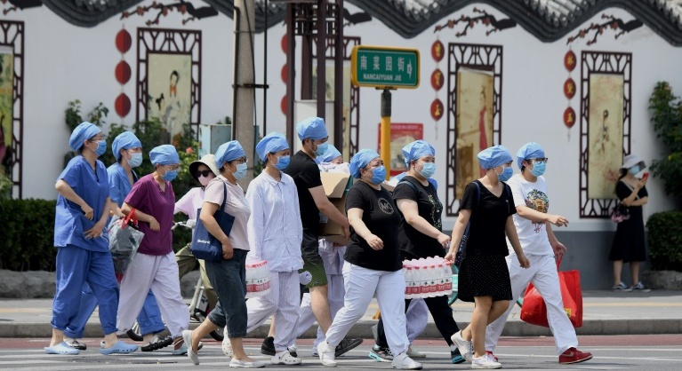 Beijing cancels flights, shuts schools over new virus outbreak