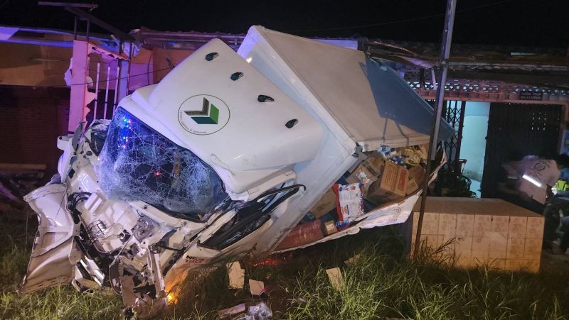 Truck hits power pole, misses house