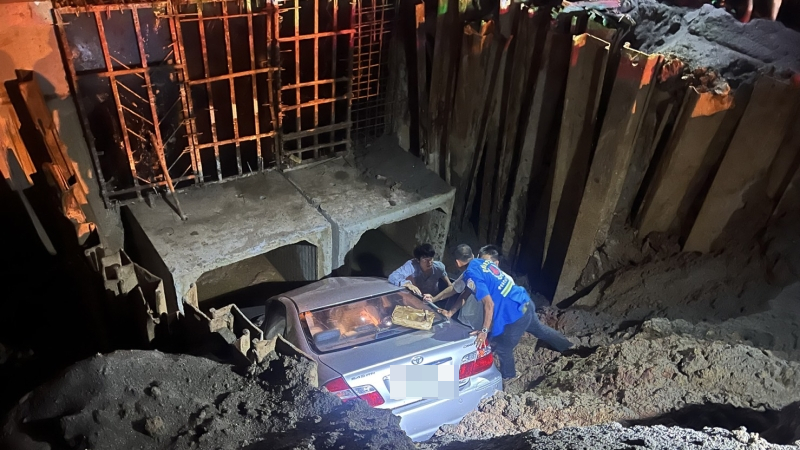 Car plunges into construction hole
